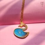 Close-up of Blue Swan Pendant showing resin pigment