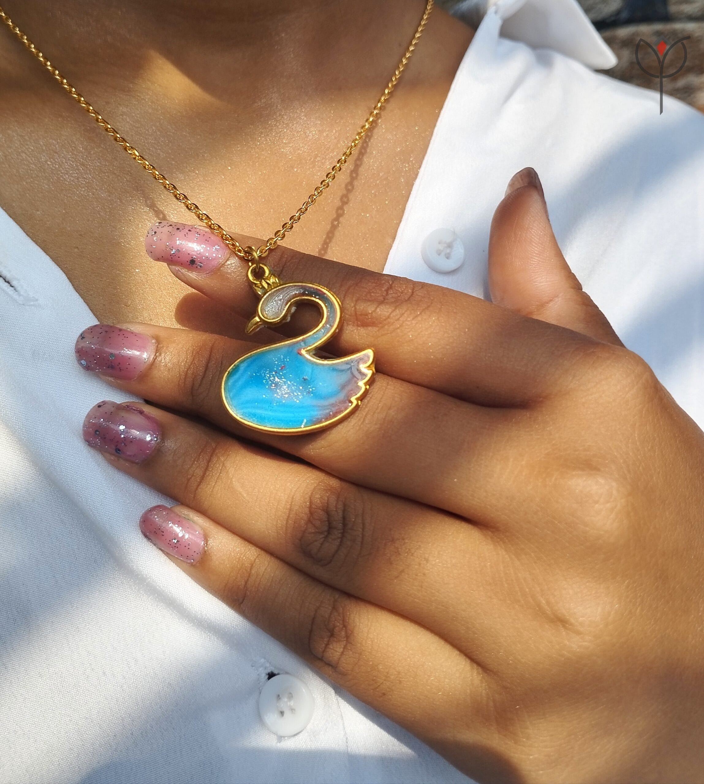 blue-swan-pendant-on-model-wear-look Model wearing Blue Swan Pendant on gold chain, swan-shaped resin jewellery