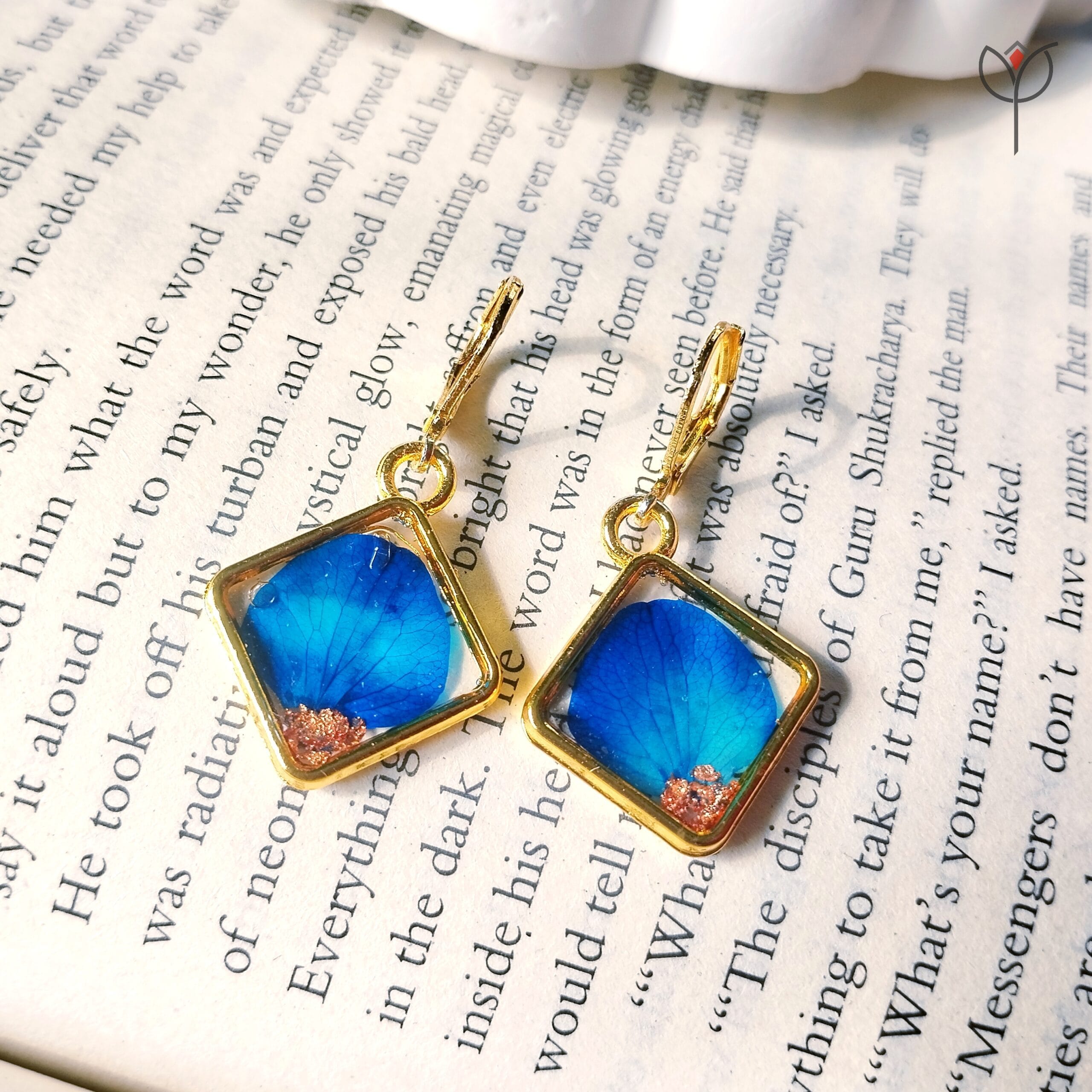 Close-up of Blue Whisper Drop Earrings showing blue petal details in resin