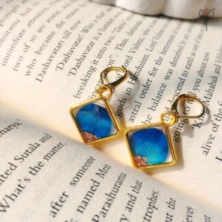 Blue Whisper Drop Earrings hanging, handcrafted floral resin jewellery