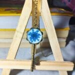 Blue Whisper Key pendant worn as a necklace