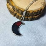 Close-up of Crimson Moon pendant in crescent moon shape