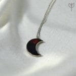 Crimson Moon pendant hanging on silver chain