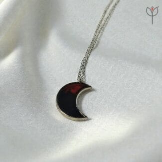 Crimson Moon pendant hanging on silver chain