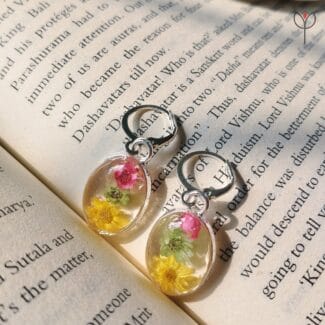 Close-up of Medley Bloom Earrings showing colourful preserved flower details in resin