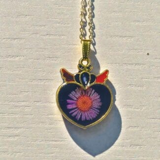 Close-up of Naughty Angel winged heart pendant