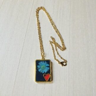 Red Heart Bloom pendant hanging on gold chain