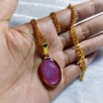 Rose Gleam Pendant worn in hand