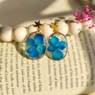 Blue resin drop earrings with real preserved blue flowers