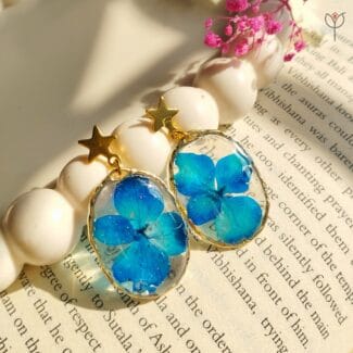 Handmade blue resin drop earrings featuring hydrange