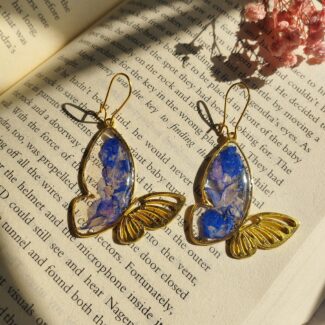Close-up of butterfly Camellia earrings showing real flower