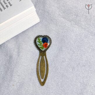 Handmade resin bookmark featuring Baby’s Breath and fern leaves