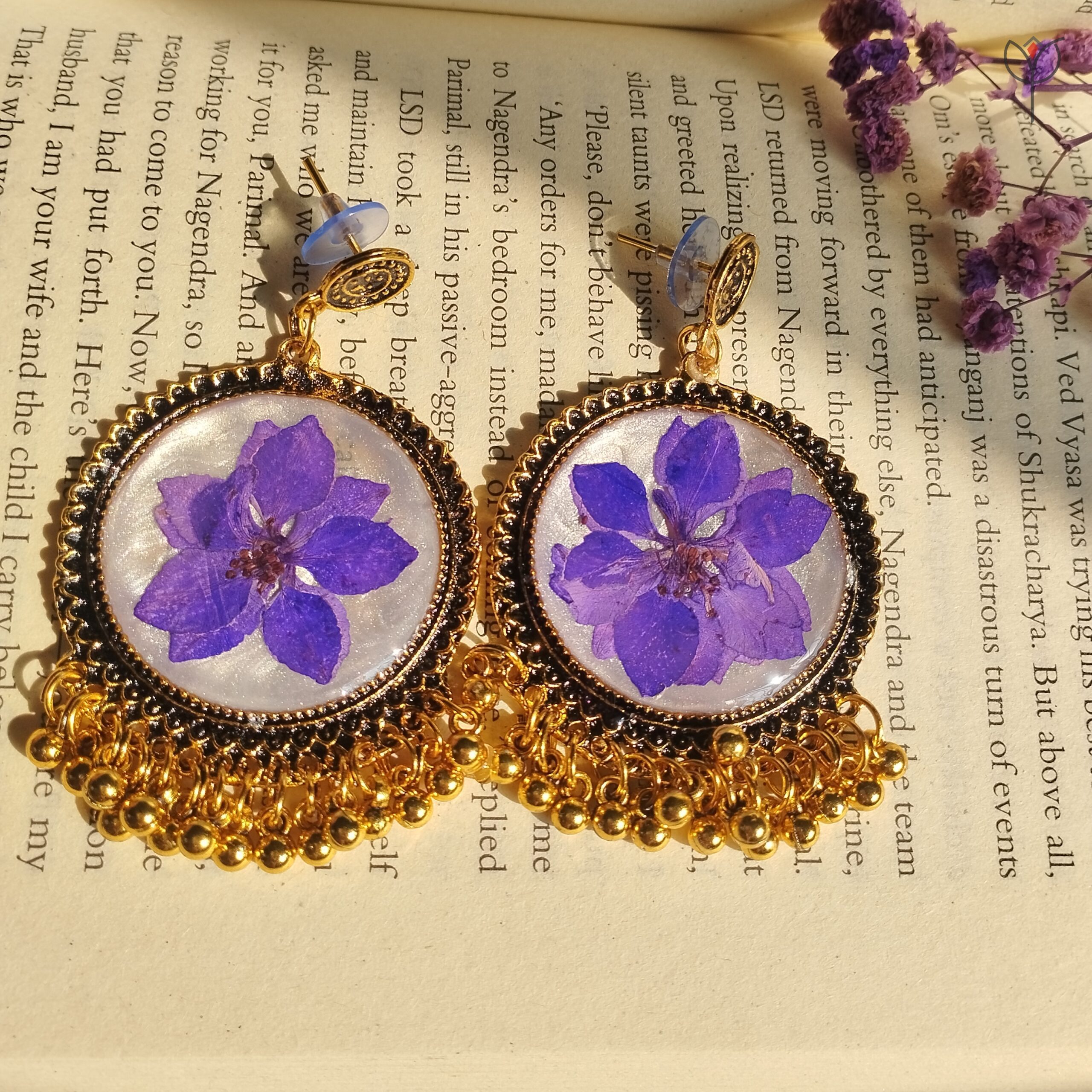 Golden oxidised floral jhumka with soft purple camellia flower
