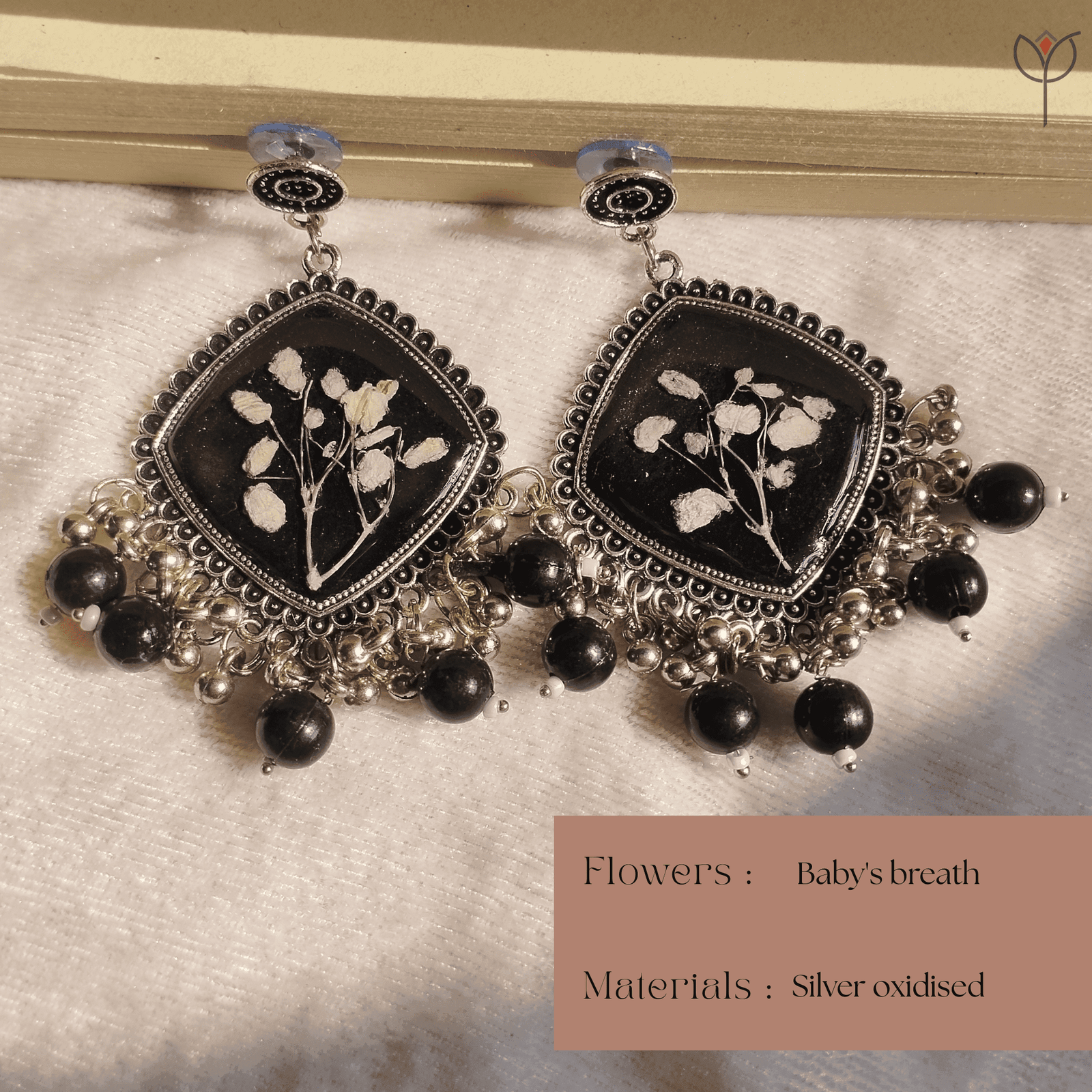 midnight-floral-resin-jhumka-real-babys-breath Handcrafted resin jhumka featuring preserved flowers
