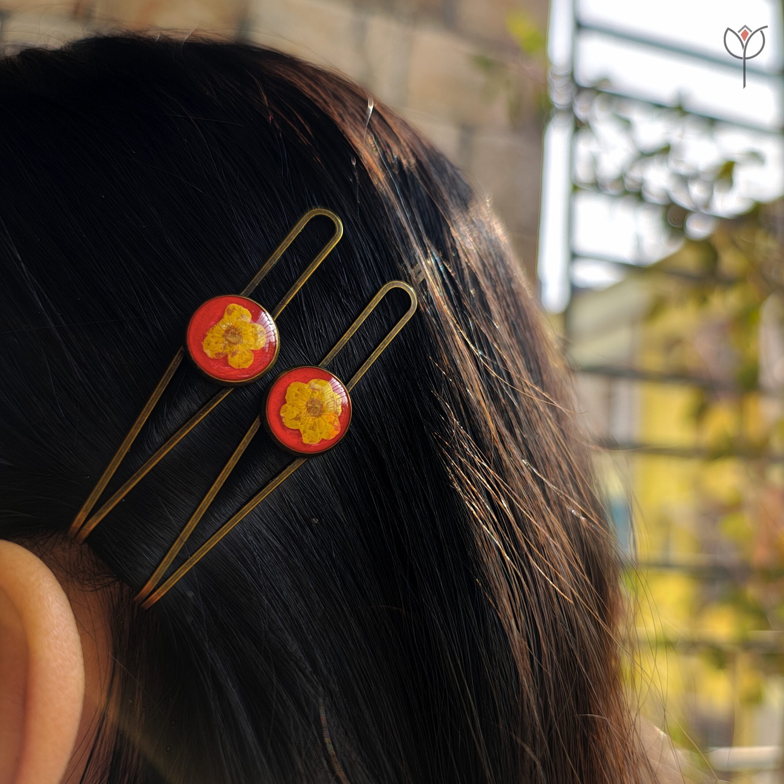 plum-resin-hair-clips-worn-in-hair Plum resin hair clips styled in hair featuring real dried plum flower