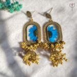 Blue daisy preserved in clear resin jhumka