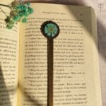 Antique scale shaped bookmark with real daisy