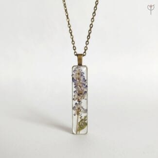 Antique style resin pendant featuring real dried flower