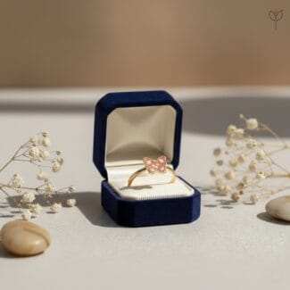 Golden butterfly finger ring featuring preserved flower