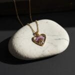 Heart-shaped gold pendant featuring real dried daisy