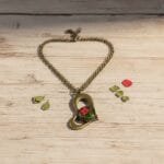 Vintage style resin pendant with fern leaf and red flower