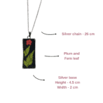 Minimal silver pendant with fern leaf and dried red flower