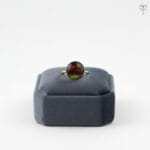 Gold ring featuring red dried flowers and fern
