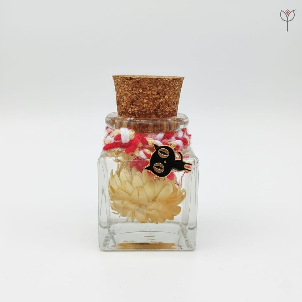 Mini sunflower preserved in mineral oil glass bottle