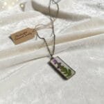 Botanist’s Secret Pendant showcasing real preserved flowers