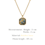 Gold-toned octagon pendant with a bright meadow motif protected by clear resin
