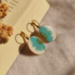 Handmade gold drop earrings with vibrant blue