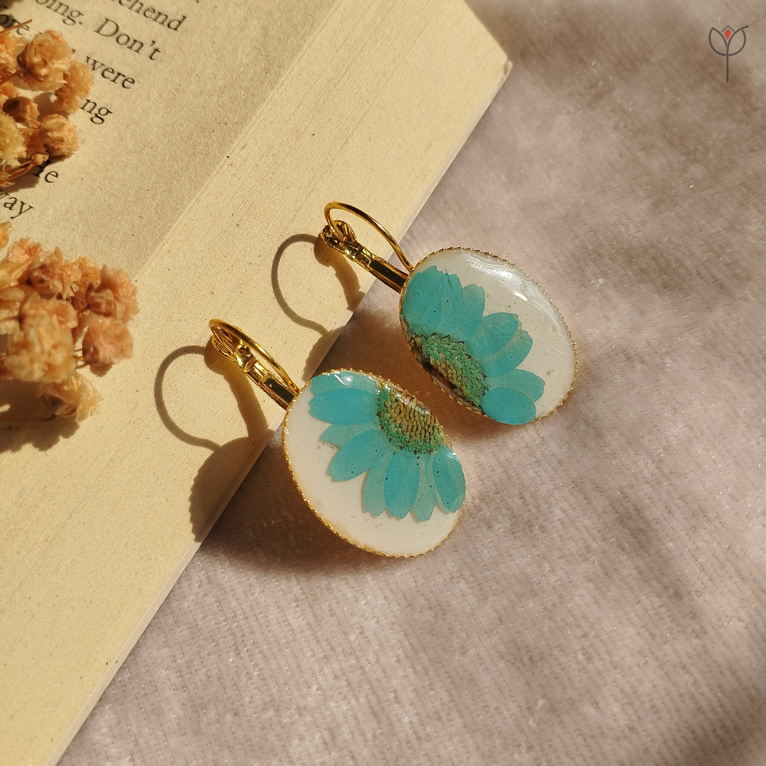 Handmade gold drop earrings with vibrant blue