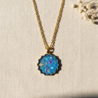 Shimmering blue pigment resin pendant