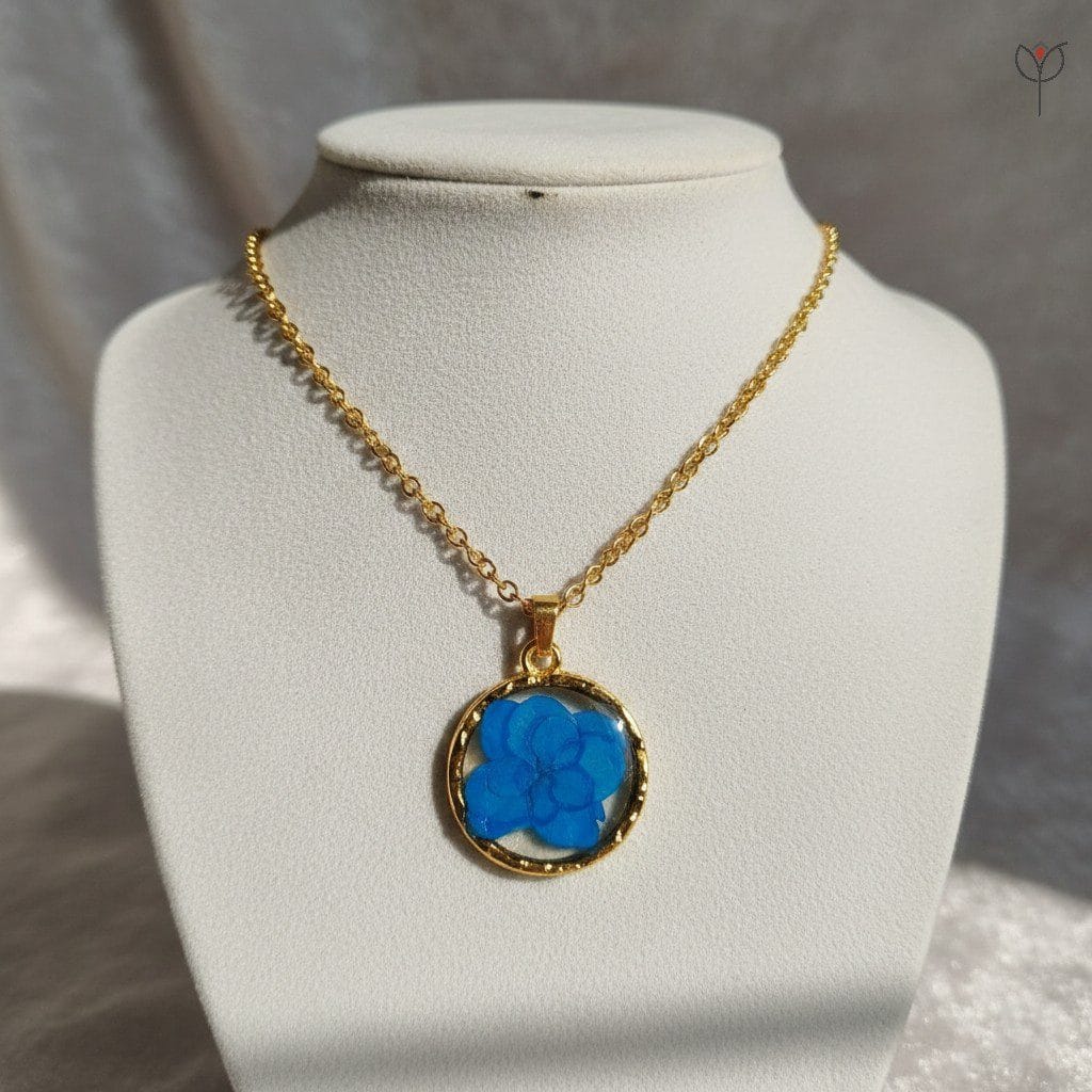 blue-hydrangea-gold-necklaces Round gold pendant featuring real preserved blue flower