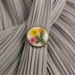 Real fern leaf and dried flowers in an Ancient Meadow Resin Brooch