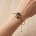 Handcrafted gold bangle featuring real preserved fern and statice in resin