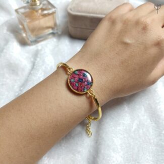 Handcrafted gold bangle with pink baby's breath and real flowers in resin