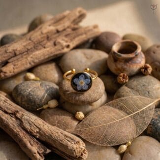 Real blue Forget-me-not flower preserved in a golden base
