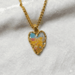 Handcrafted heart necklace with a textured gold frame