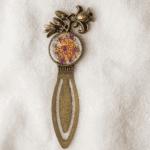 Close-up of a crowned boho bookmark with a floral resin center