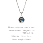 Close up of a handcrafted botanical pendant on a silver chain