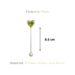 Real plum flowers preserved in a heart-shaped resin brooch