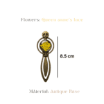 Antique bronze skull bookmark with runic symbols and yellow Queen Anne's Lace