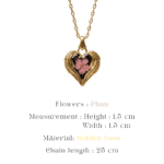 Detailed view of a handcrafted floral pendant on a gold chain
