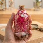 Mineral oil preserved pink baby’s breath glass bottle decor