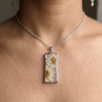 Handmade silver necklace featuring the Dewy Daisy Pendant