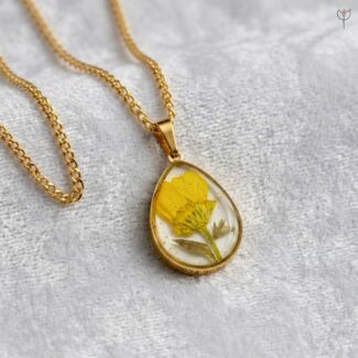 Sunny Aura Pendant with a yellow flower on a white background