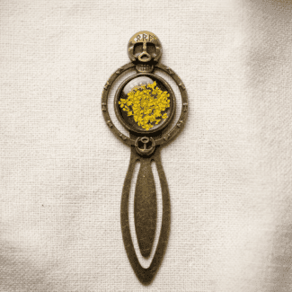 The Runecaster’s bookmark featuring a real yellow Queen Anne's Lace
