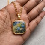 Handcrafted resin necklace featuring a sun-drenched floral illustration