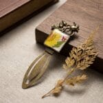 Handcrafted resin bookmark with real pressed daisy and ornate metal crown